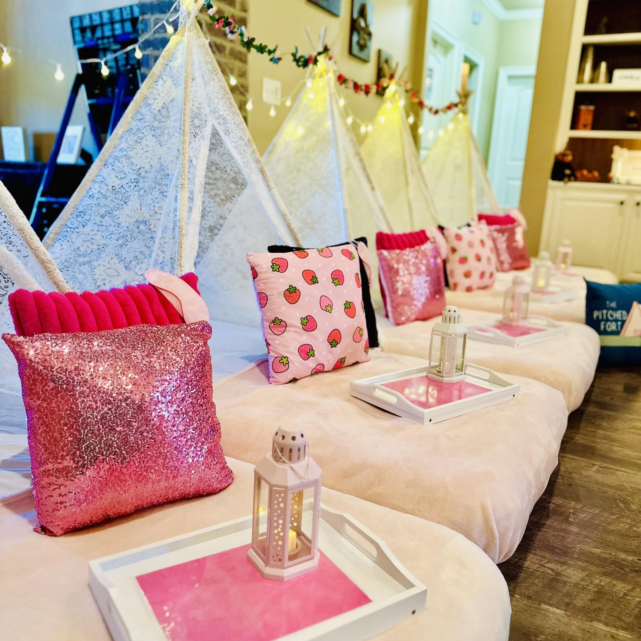 A styled Pitched Fort sleepover setup with pink pillows and cozy details